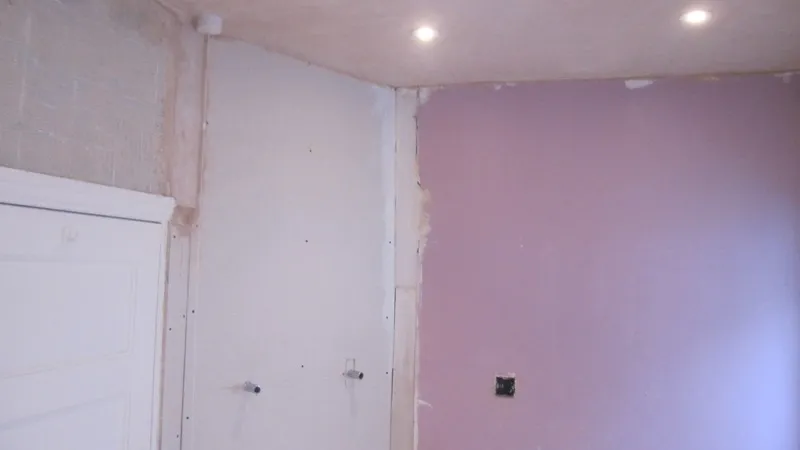 Before: the same bathroom walls before plastering